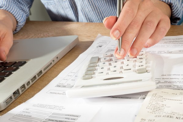 accounting software man on laptop with calculator bookkeeping